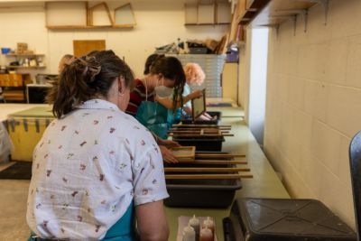 Students work on paper art projects