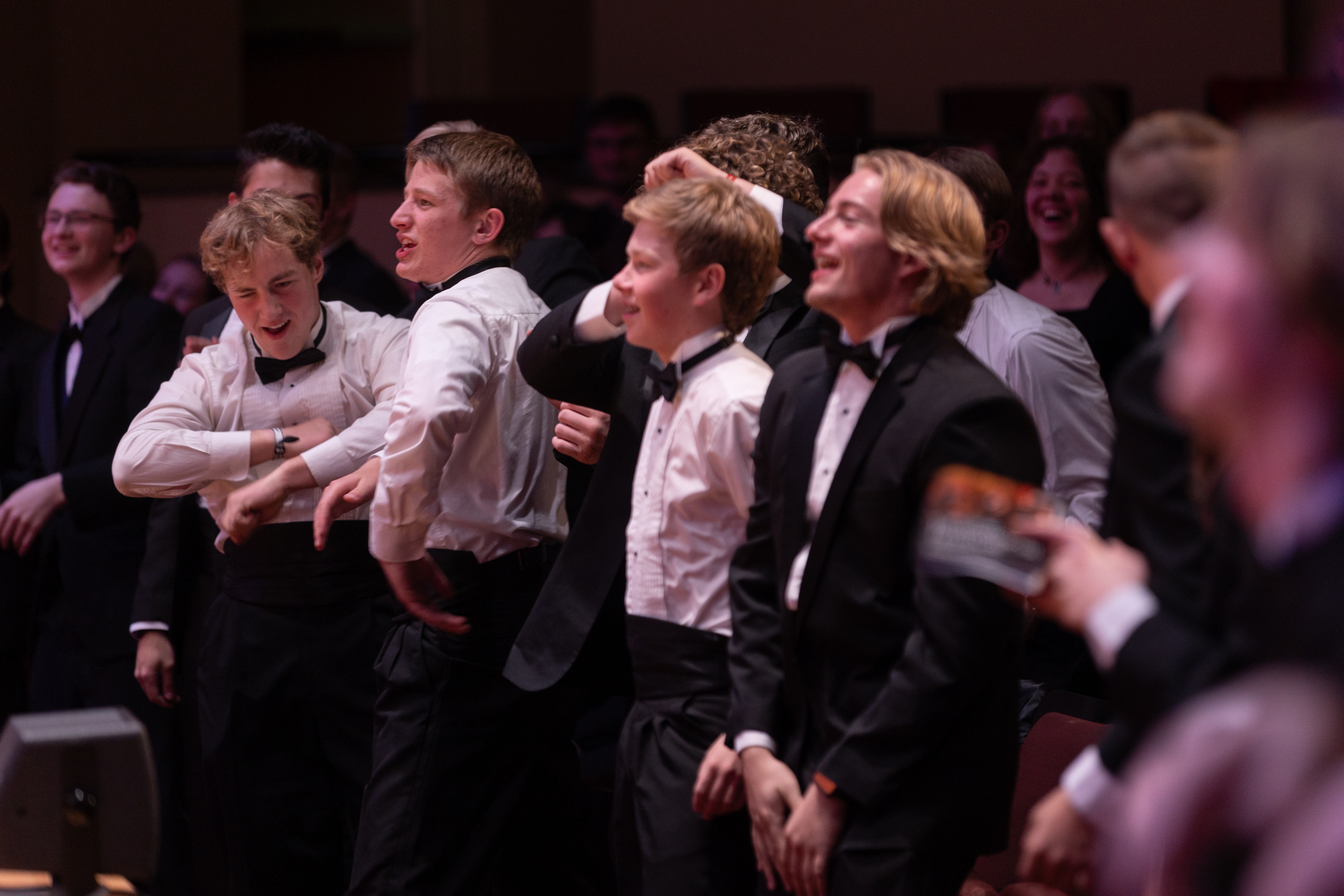 Multiple well dressed young men dancing