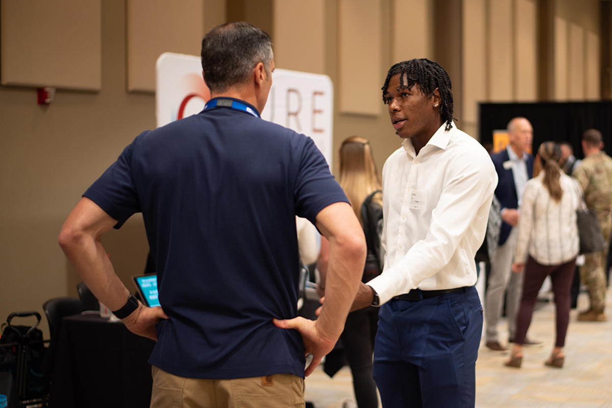 Student speaking with recruiter at career fair