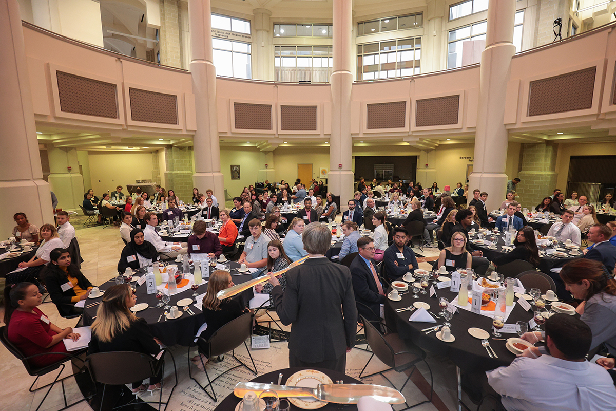 Students watching presentation at etiquette dinner