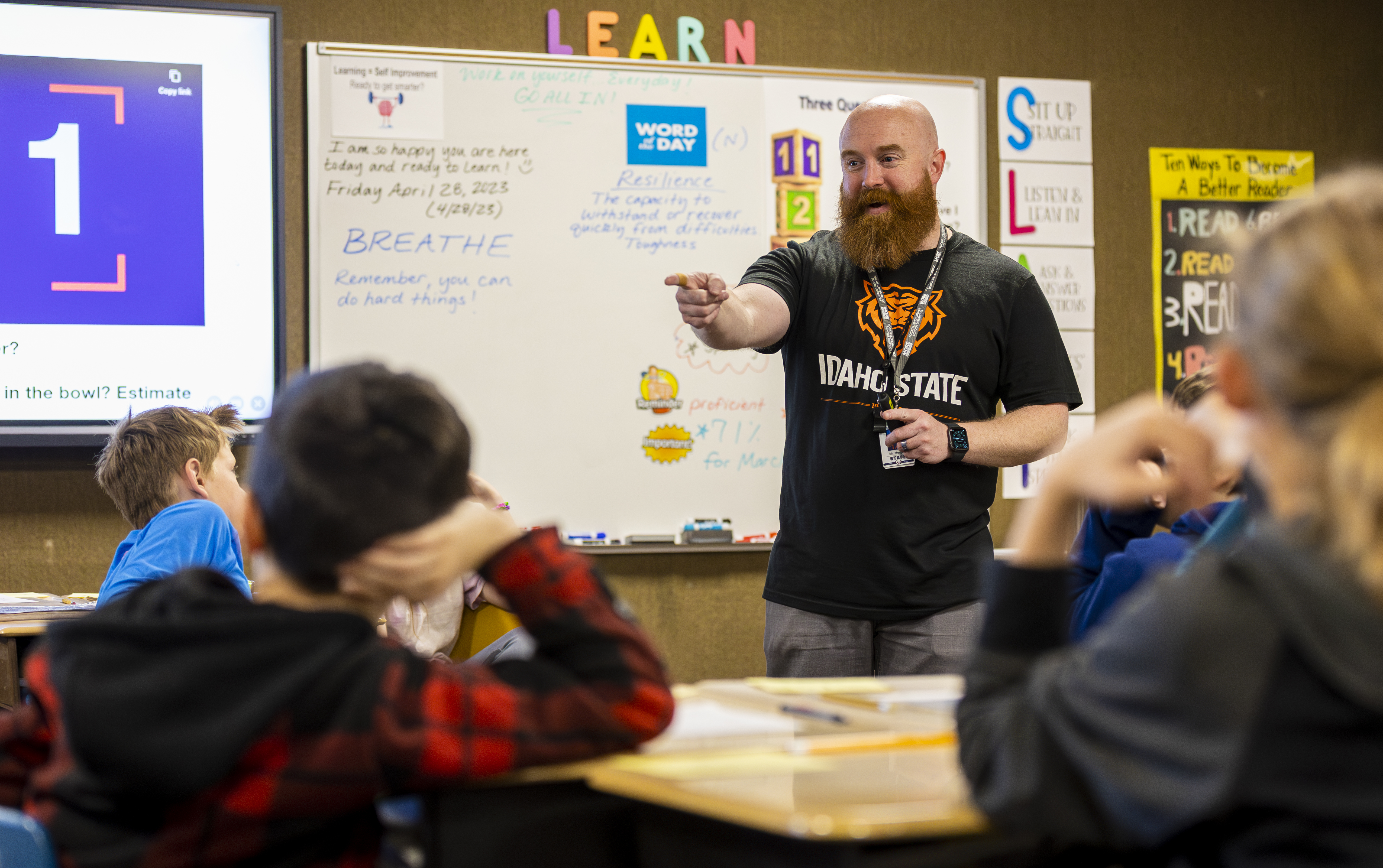 An alum teacher teaching his elementary school class