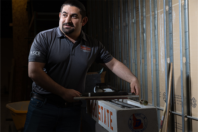 Mustafa Mashal, associate professor in the Department of Civil and Environmental Engineering, speaks to colleagues about ductile connections for pre-formed construction elements, at Idaho State University's Structural Laboratory.