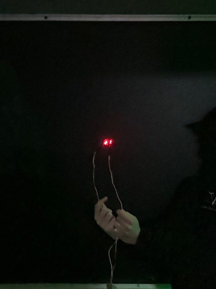 A closeup of two lit LEDs very close to each other