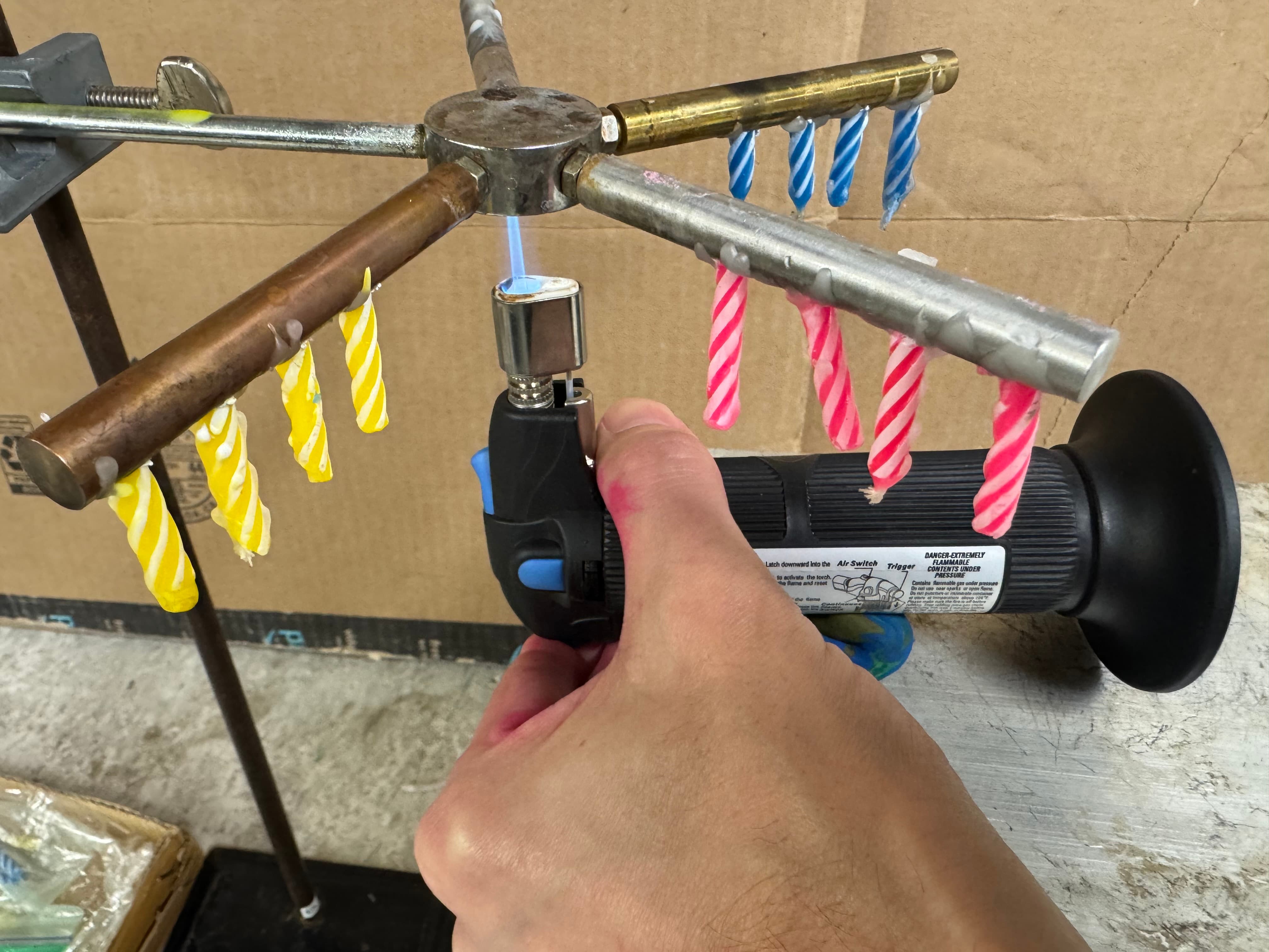 Performer lighting the torch under the Conductometer Heat aparatus.