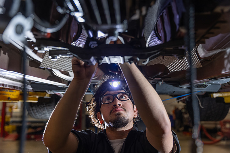 Automotive Technology Student working on a car