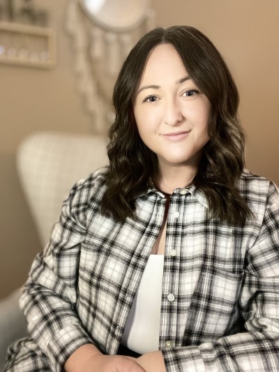 Jessica Ivanic sitting in a chair and smiling.