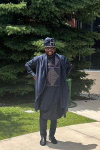 Hassan Oyindamola Taiwo posing in front of a tree