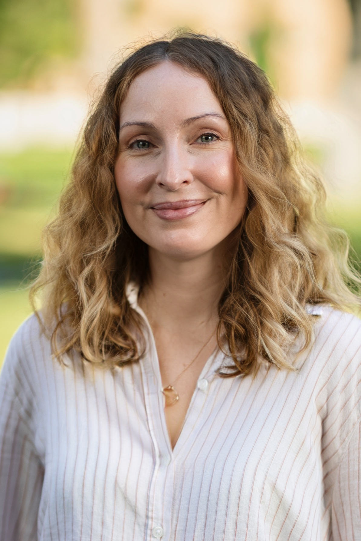 Head shot of woman in white shirt