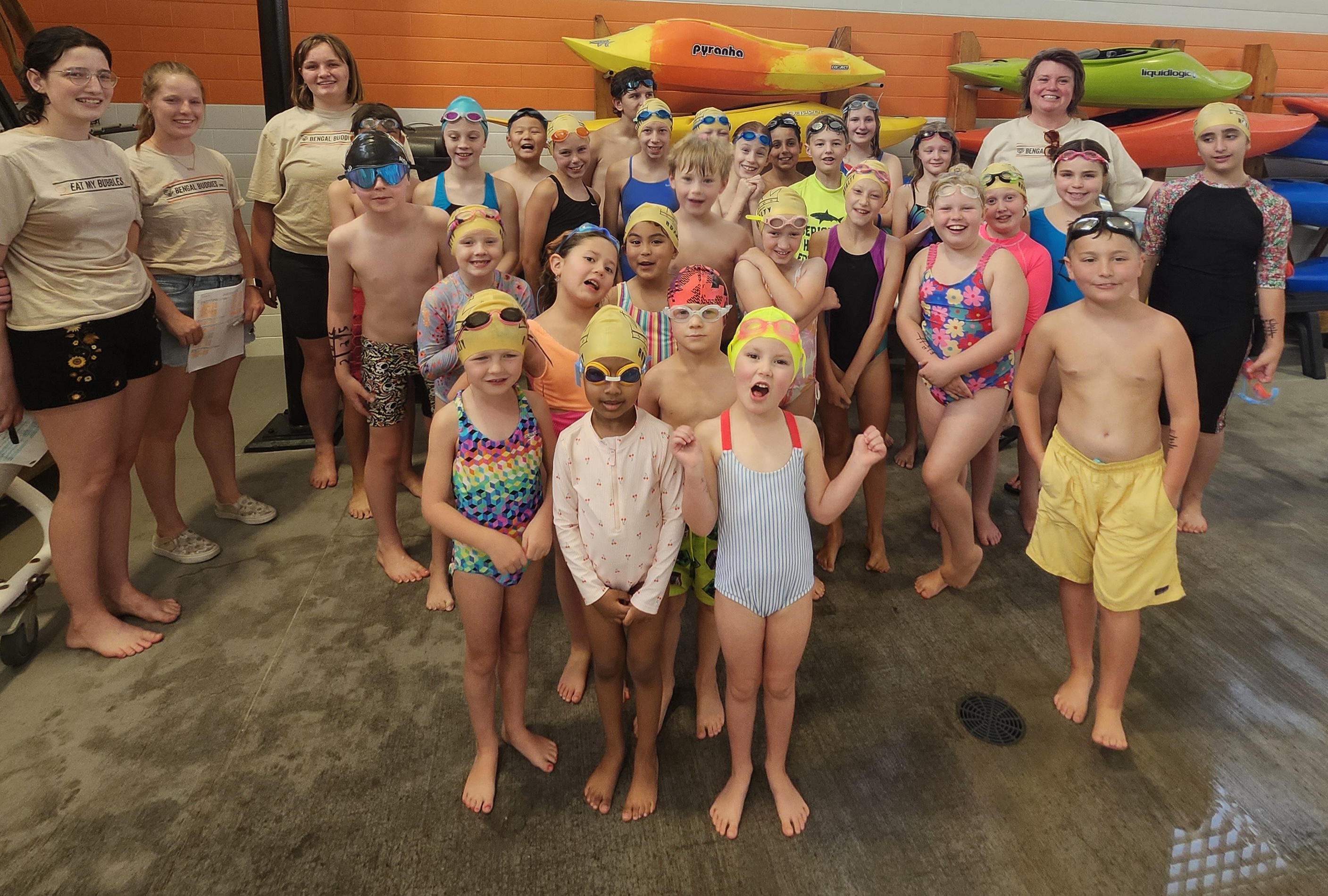 Adorable children team picture swimming with coaches