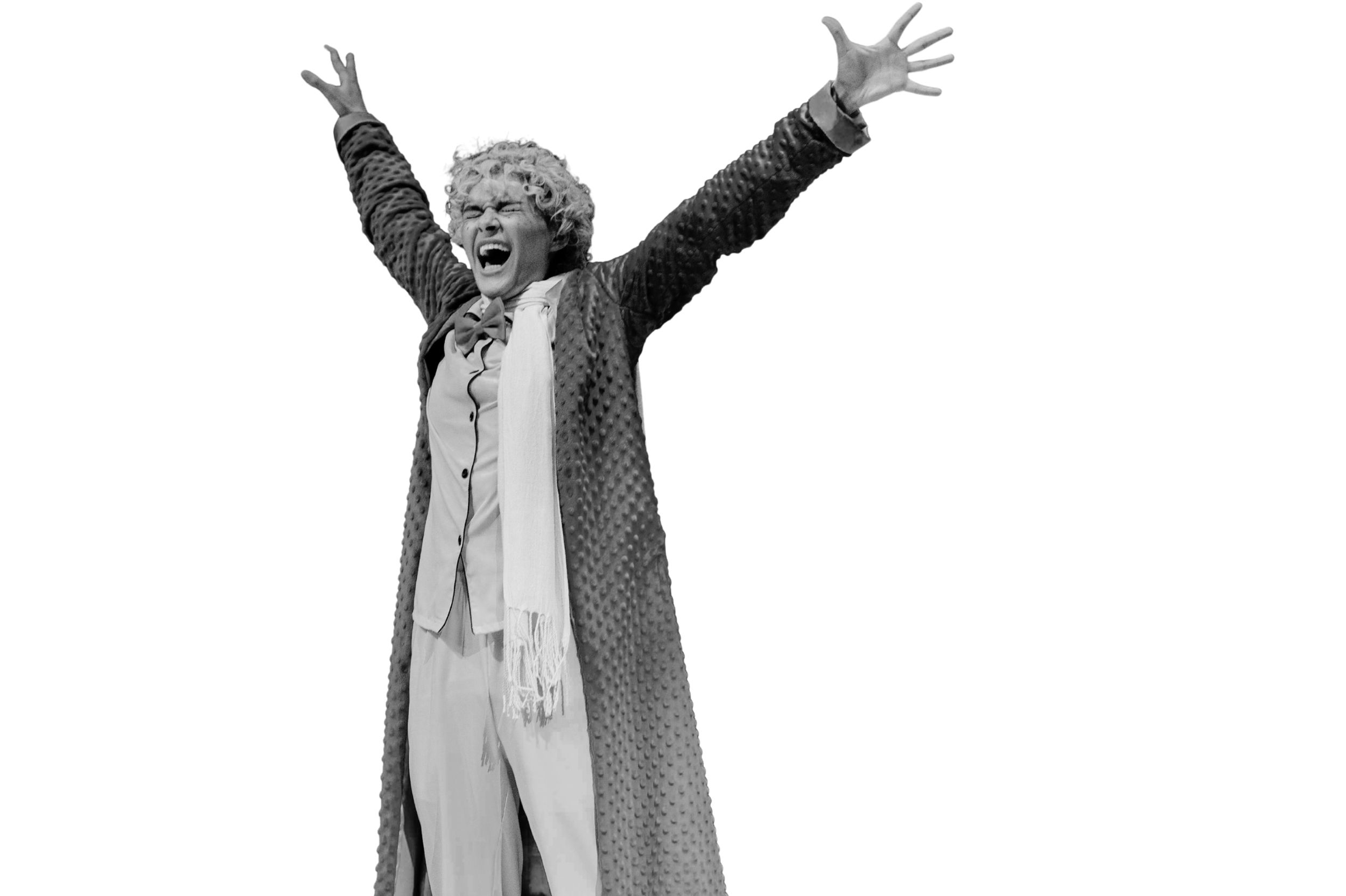 Student onstage lifting arms up in expression of excitement