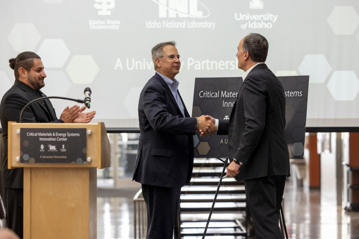 Two men shake hands