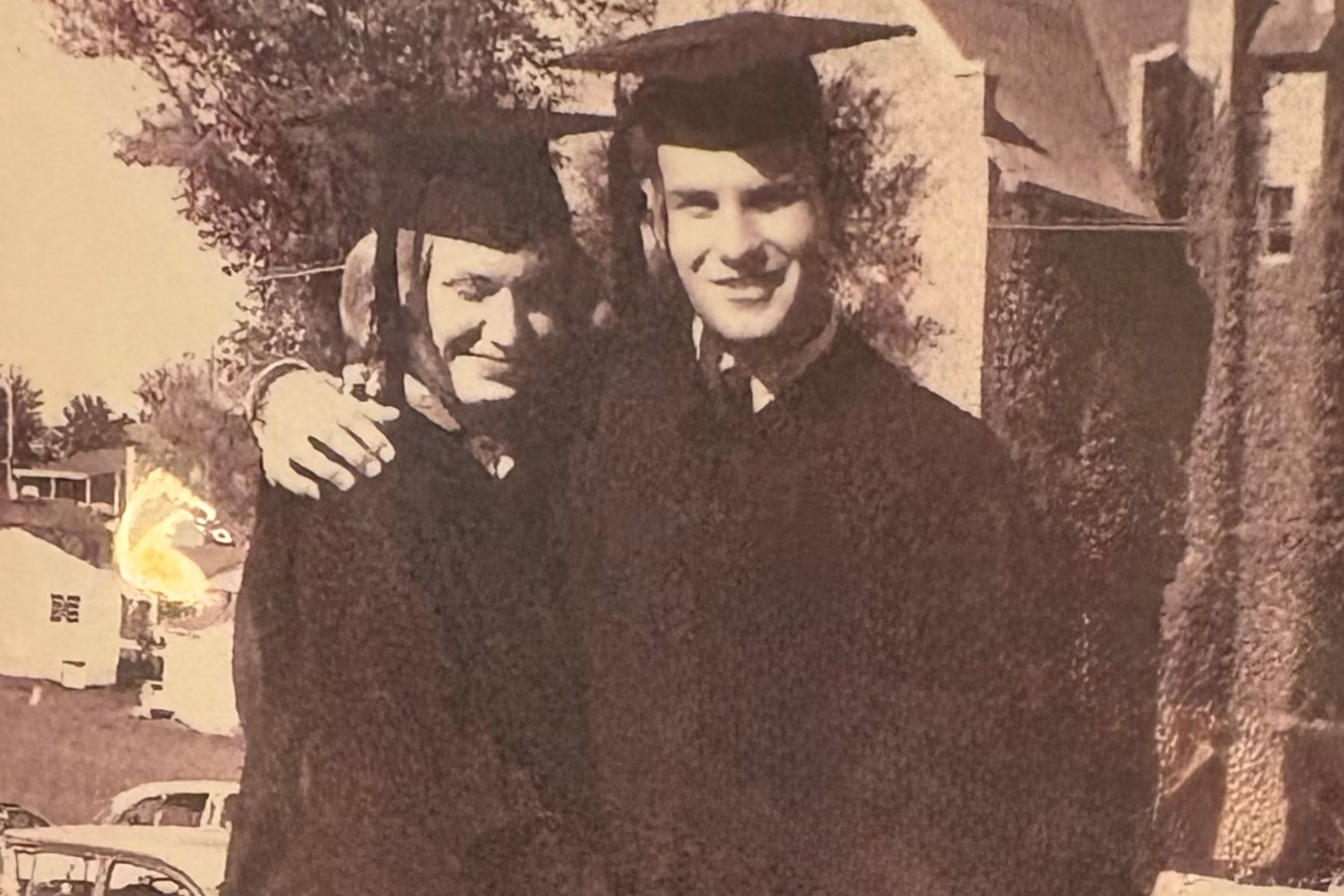 Old black and white photo of John and Marilyn Henderson in graduation attire