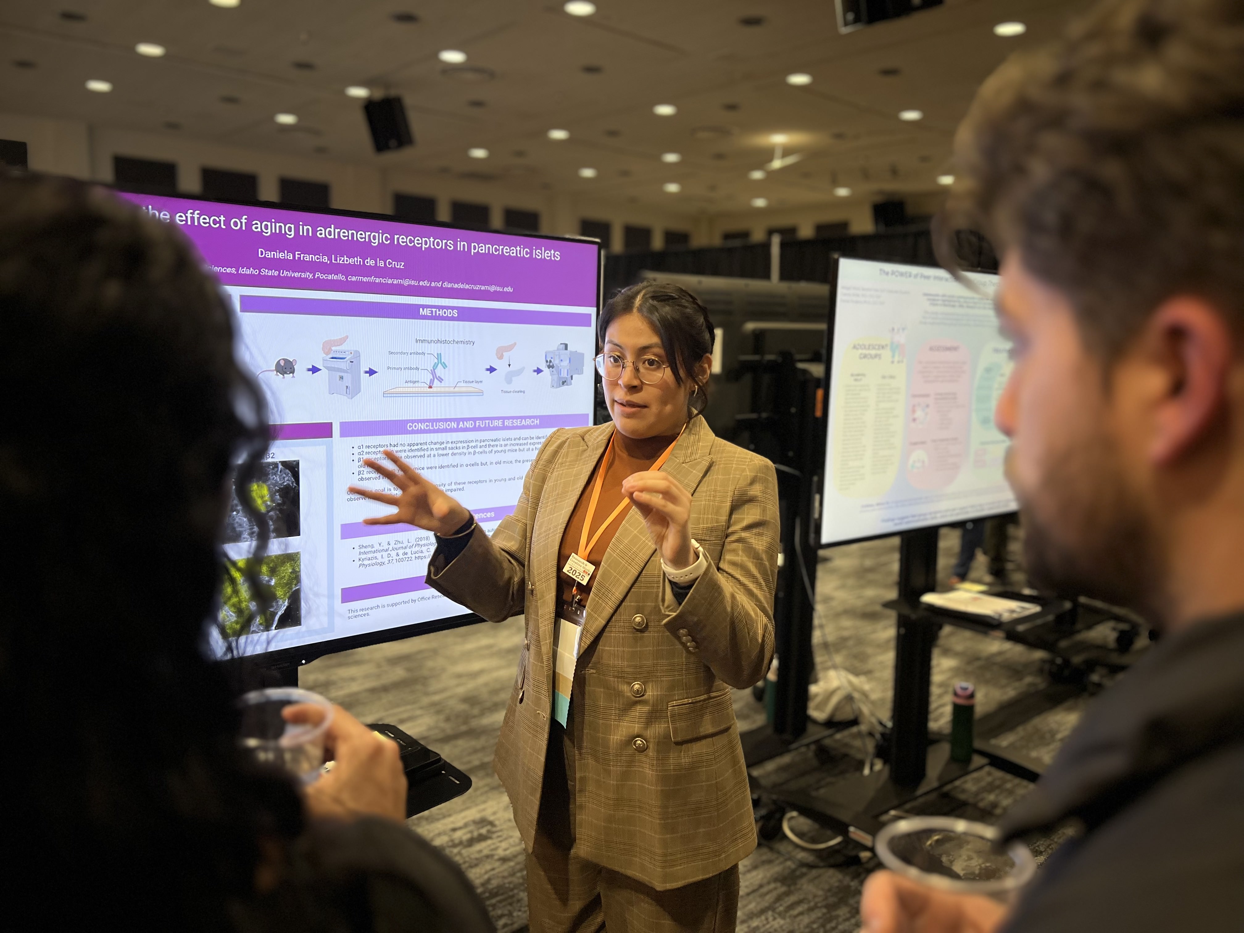 A student presents her poster at the Research and Creative Works Symposium 2025