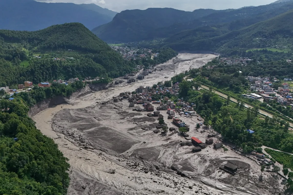 Damaged houses stand precariously near the swollen, debris-choked banks of the Trishuli River after flash floods in Nepal's Nuwakot district on Wednesday. Photo credit: Niranjan Shrestha/AP