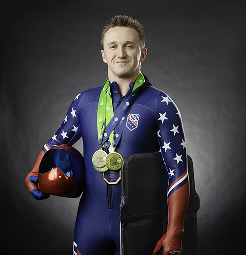 Olympic skeleton racer with helmet, sled and medals