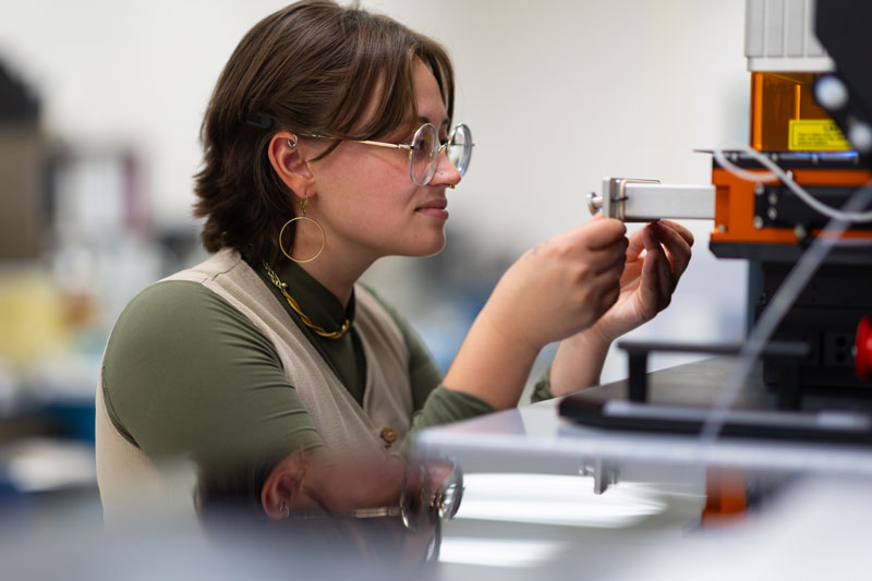 Cheyenne Eartelt, a master's student in geology, loads Zircon samples into ISU's mass spectrometer and laser ablation system